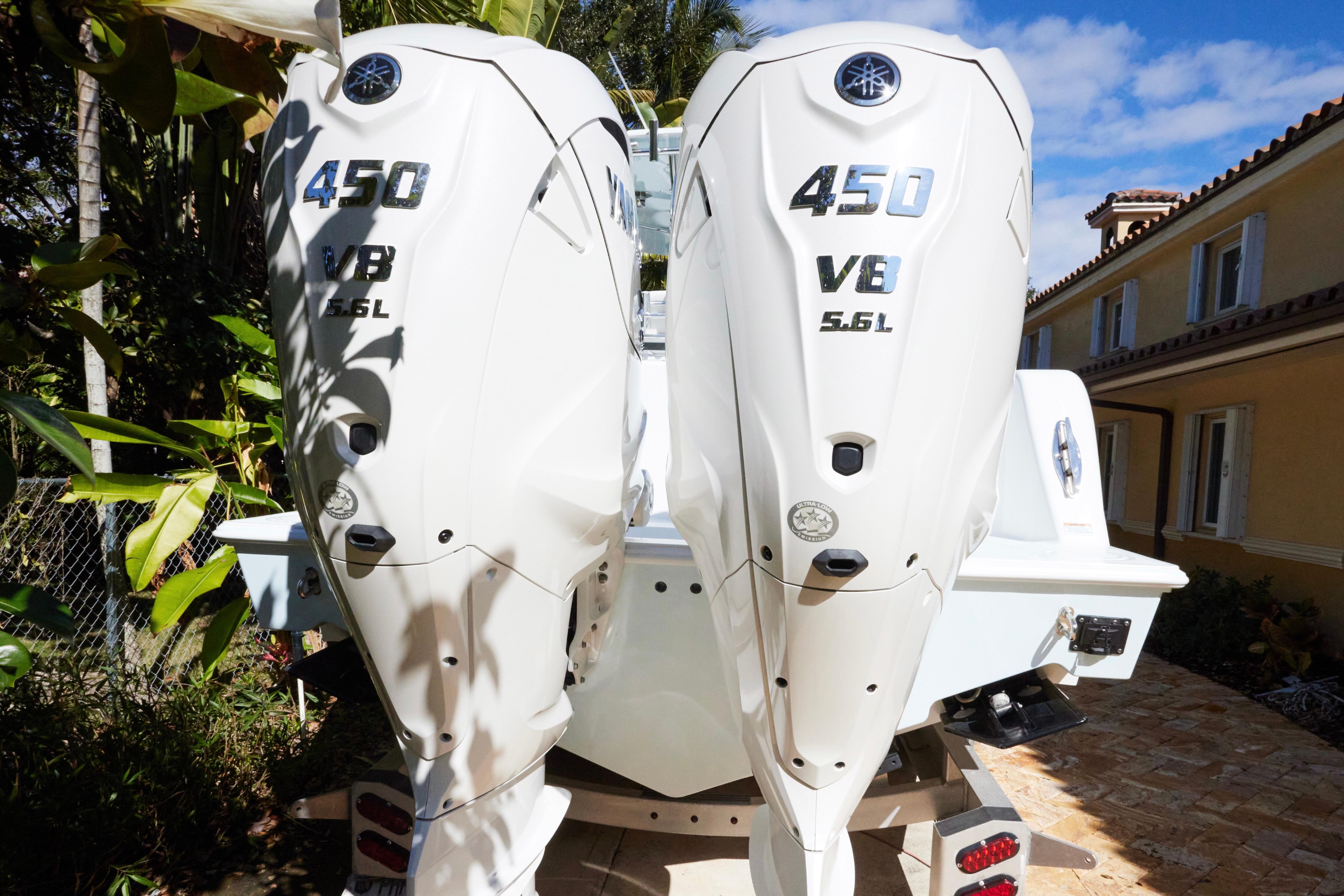 2024 Contender 35 ST boat with twin 450 V8 5.6L engines, parked outdoors.