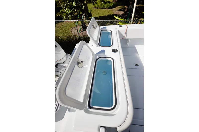  Yacht Photos Pics 2024 Contender 35 ST boat with open storage compartments and blue interior.