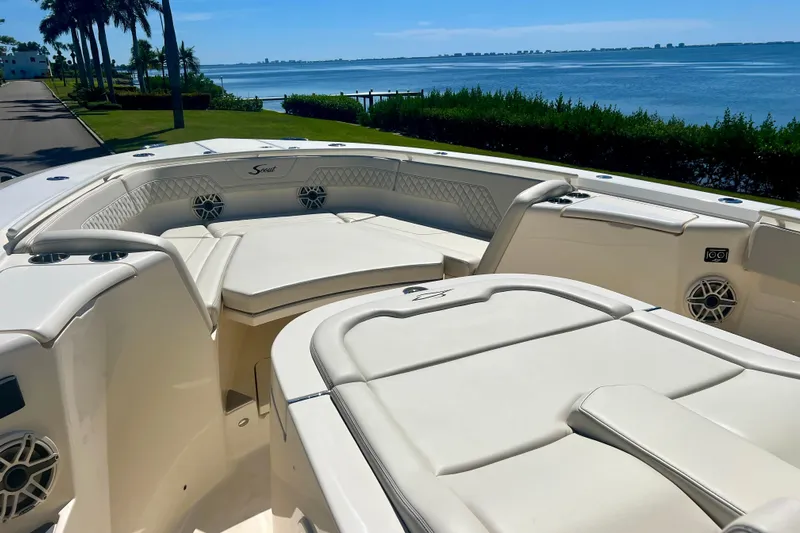  Yacht Photos Pics 2026 Scout 357 LXF boat with luxurious seating, overlooking a scenic waterfront.