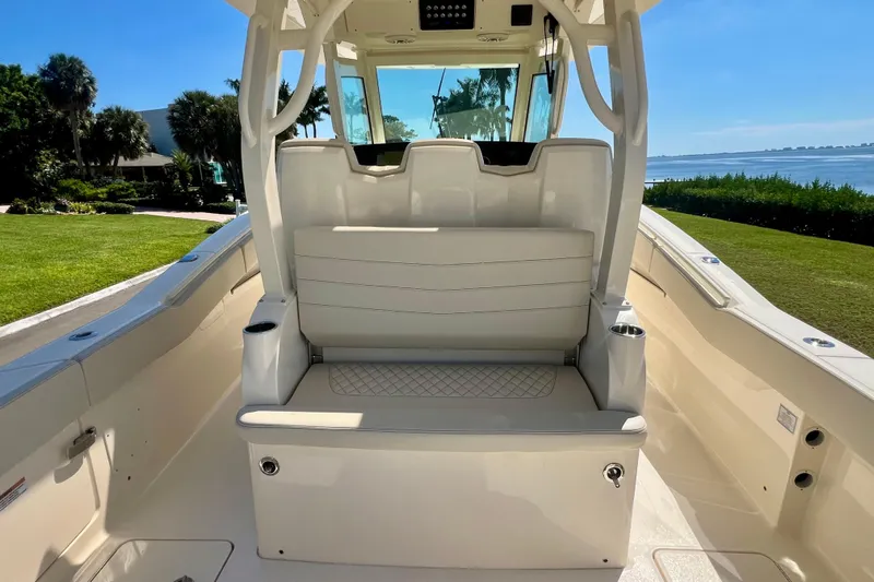  Yacht Photos Pics 2026 Scout 357 LXF boat interior with seating, overlooking a scenic waterfront.