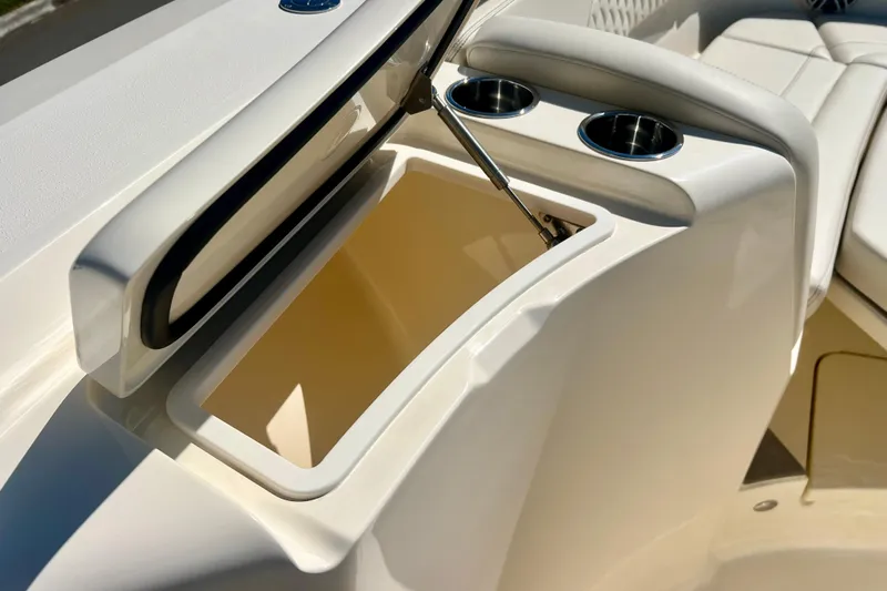  Yacht Photos Pics 2026 Scout 357 LXF boat storage compartment with cup holders, open lid, and sleek design.