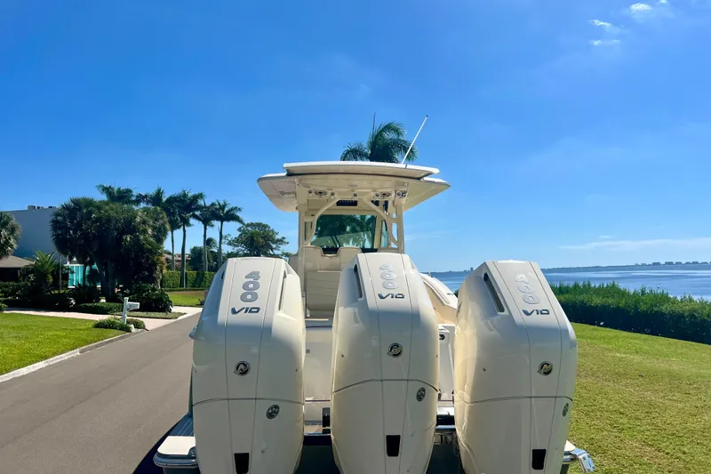  Yacht Photos Pics 2026 Scout 357 LXF boat with triple 400 V10 engines, parked near waterfront.