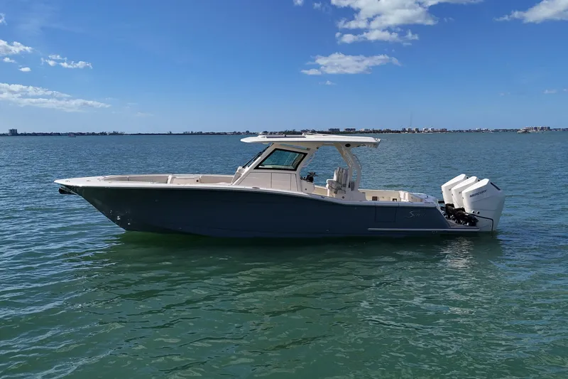  Yacht Photos Pics 2026 Scout 357 LXF boat on calm water under a clear blue sky.