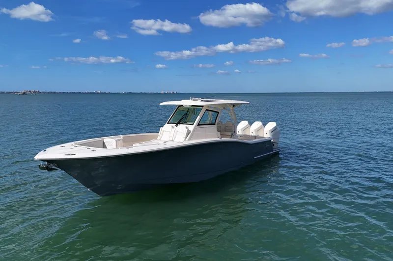  Yacht Photos Pics 2026 Scout 357 LXF boat on calm blue water under a clear sky.