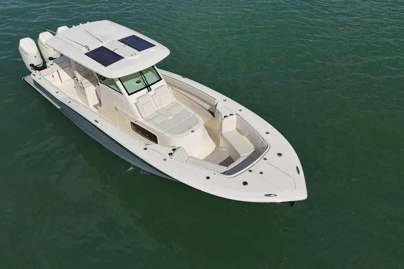  Yacht Photos Pics 2026 Scout 357 LXF boat on calm water, featuring sleek design and triple engines.