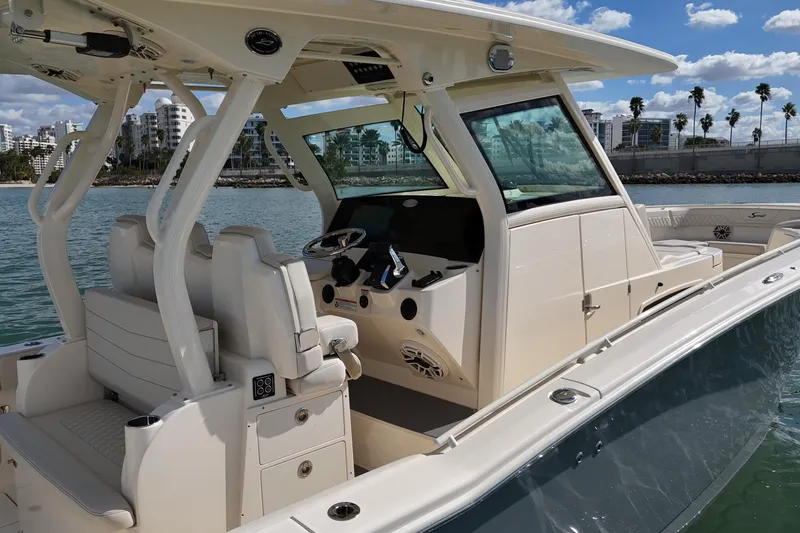 Yacht Photos Pics 2026 Scout 357 LXF boat interior with helm, seats, and ocean backdrop.