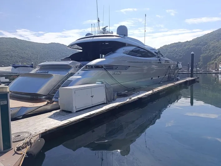 Gamma Yacht Photos Pics Luxury 2007 Pershing 115 yacht docked at marina with scenic mountain backdrop.
