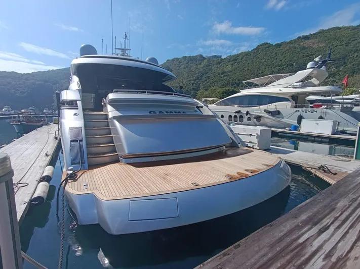 Gamma Yacht Photos Pics Luxury 2007 Pershing 115 yacht docked at marina, surrounded by scenic hills.
