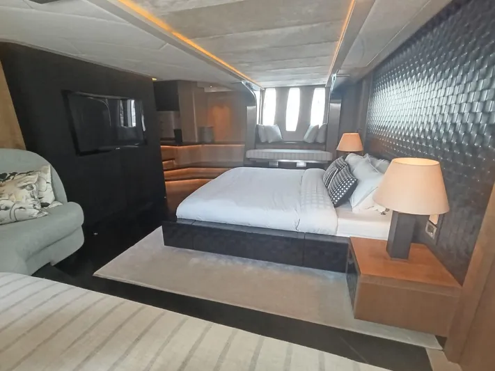 Gamma Yacht Photos Pics Luxurious bedroom interior of a 2007 Pershing 115 yacht with modern decor and ambient lighting.