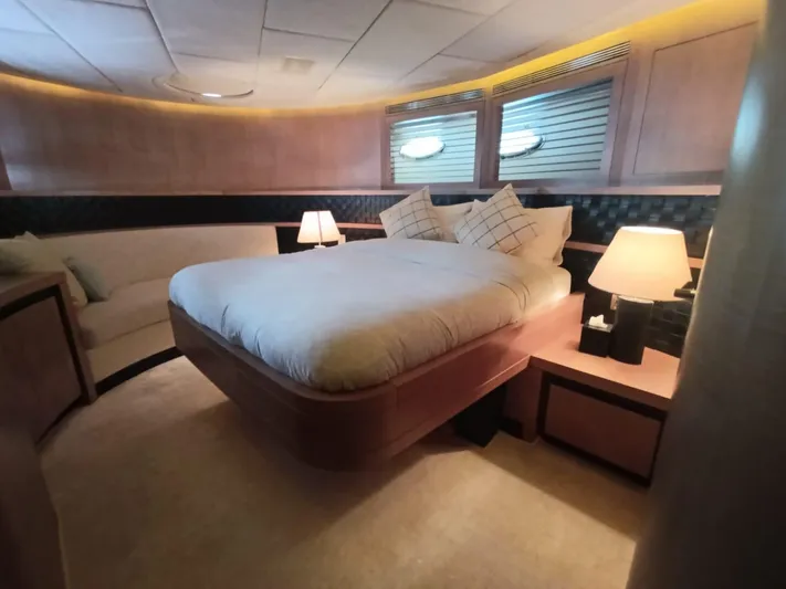 Gamma Yacht Photos Pics Luxurious bedroom interior of a 2007 Pershing 115 yacht with elegant lighting and decor.