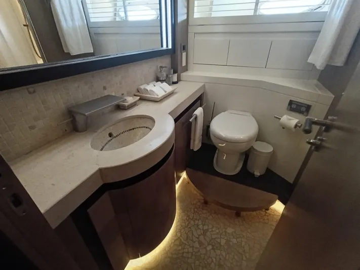 Gamma Yacht Photos Pics Luxurious bathroom in a 2007 Pershing 115 yacht, featuring modern fixtures and ambient lighting.