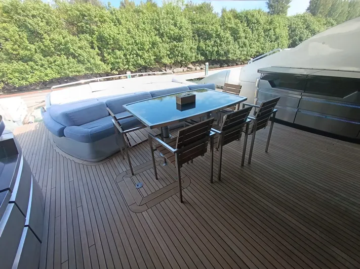Gamma Yacht Photos Pics Outdoor deck of 2007 Pershing 115 yacht with seating and dining area.