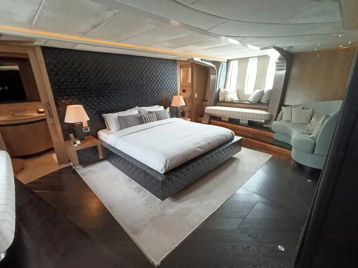 Gamma Yacht Photos Pics Luxurious bedroom interior on a 2007 Pershing 115 yacht, featuring elegant decor and modern furnishings.