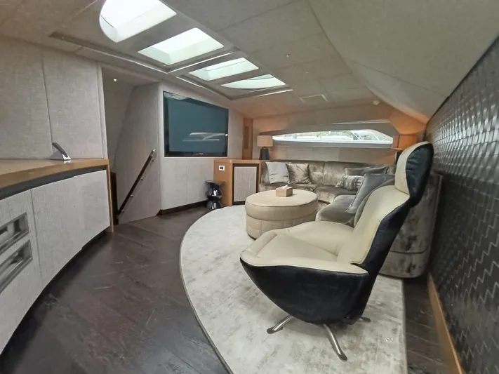 Gamma Yacht Photos Pics Luxurious interior of a 2007 Pershing 115 yacht with modern seating and entertainment area.