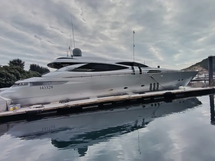 Gamma Yacht Photos Pics Luxury 2007 Pershing 115 yacht docked, reflecting on calm water under cloudy skies.