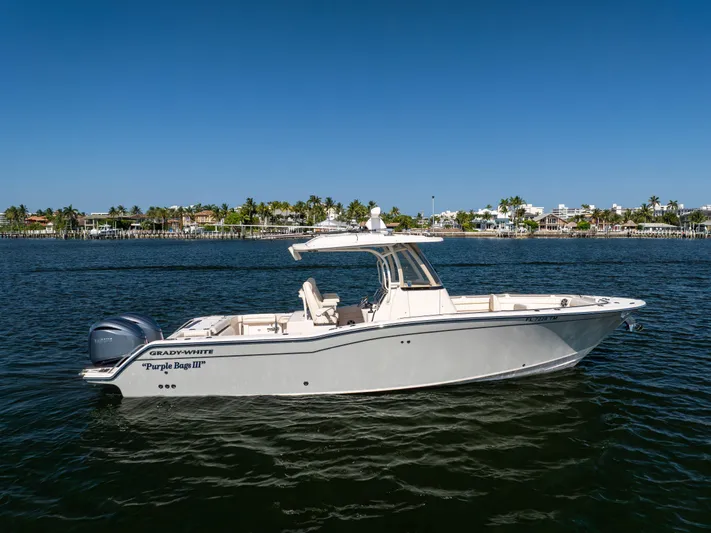 Purple Bags 2 Yacht Photos Pics 2023 Grady-White Canyon 326 boat on calm water under clear blue sky.