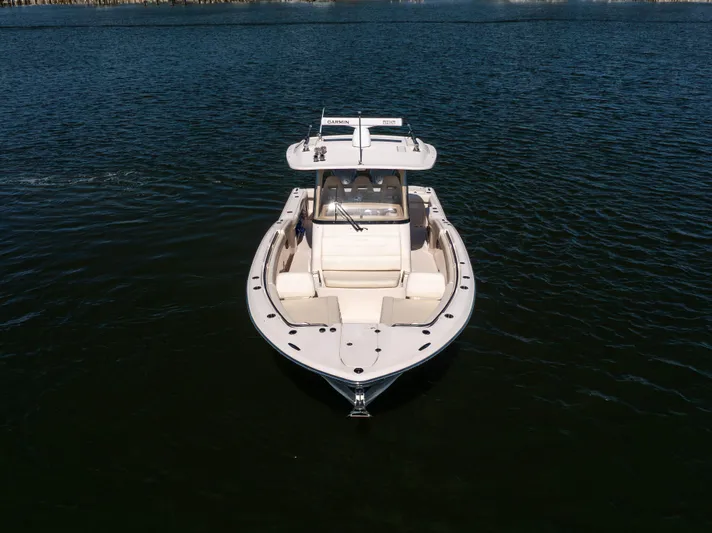 Purple Bags 2 Yacht Photos Pics 2023 Grady-White Canyon 326 boat on calm water, front view.