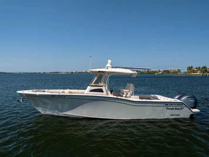 Purple Bags 2 Yacht Photos Pics 2023 Grady-White Canyon 326 boat on calm water, side view.