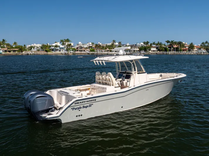 Purple Bags 2 Yacht Photos Pics 2023 Grady-White Canyon 326 boat on water, clear sky, coastal background.