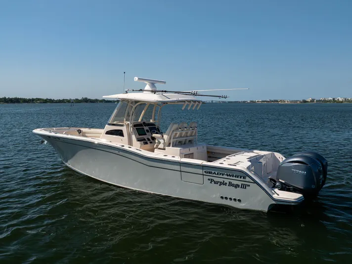 Purple Bags 2 Yacht Photos Pics 2023 Grady-White Canyon 326 boat on calm water, side view.