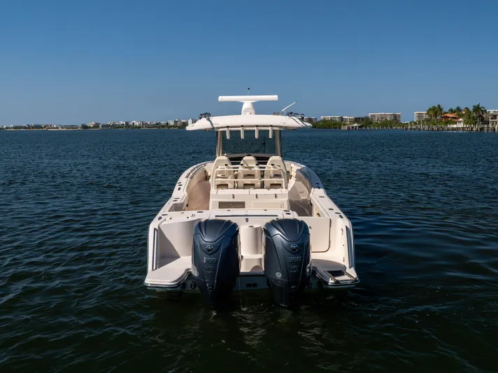 Purple Bags 2 Yacht Photos Pics 2023 Grady-White Canyon 326 boat on water, rear view with dual engines.