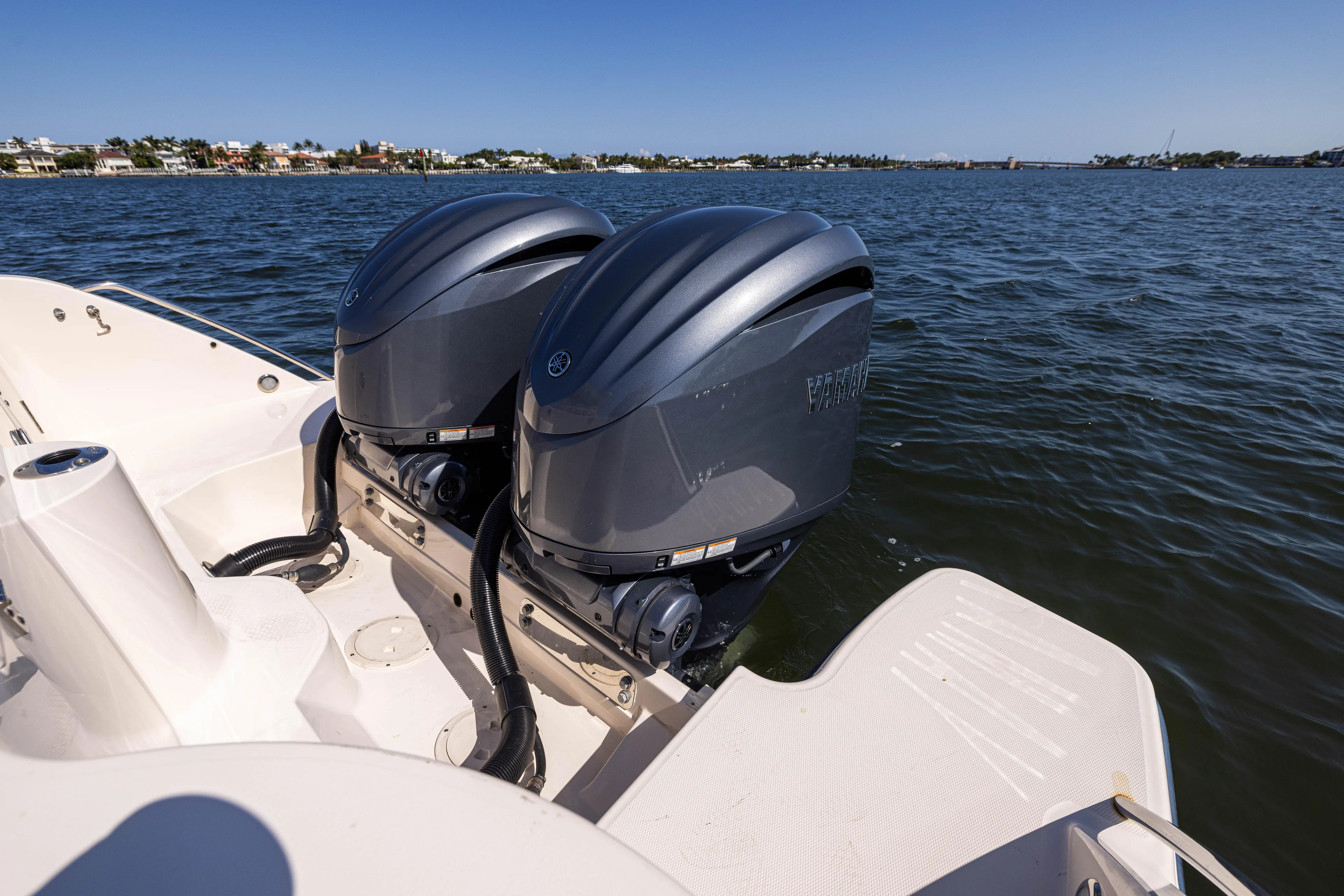 Purple Bags 2 Yacht Photos Pics 2023 Grady-White Canyon 326 boat with dual outboard engines on a calm waterway.