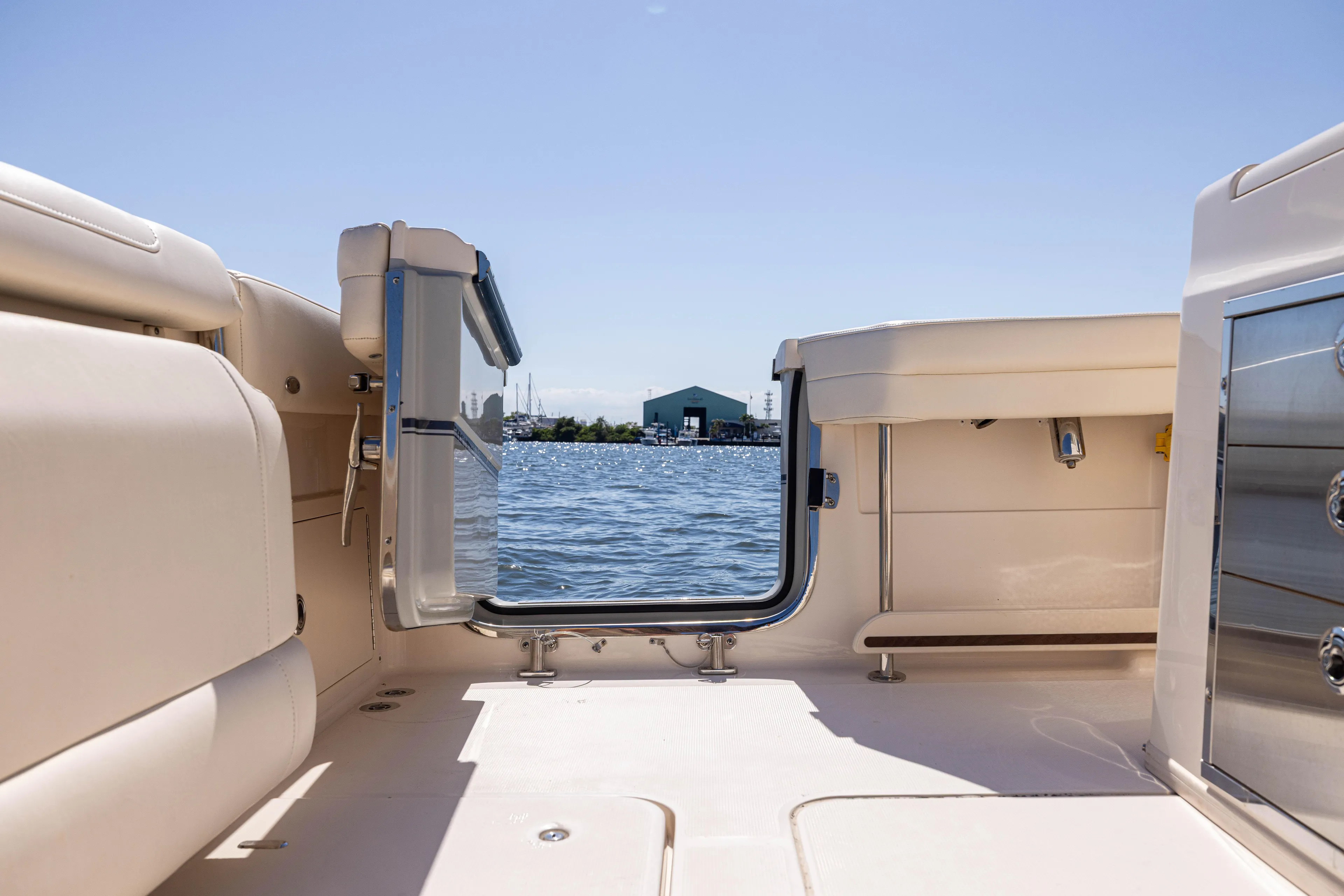 Purple Bags 2 Yacht Photos Pics 2023 Grady-White Canyon 326 boat interior with open door, overlooking water.