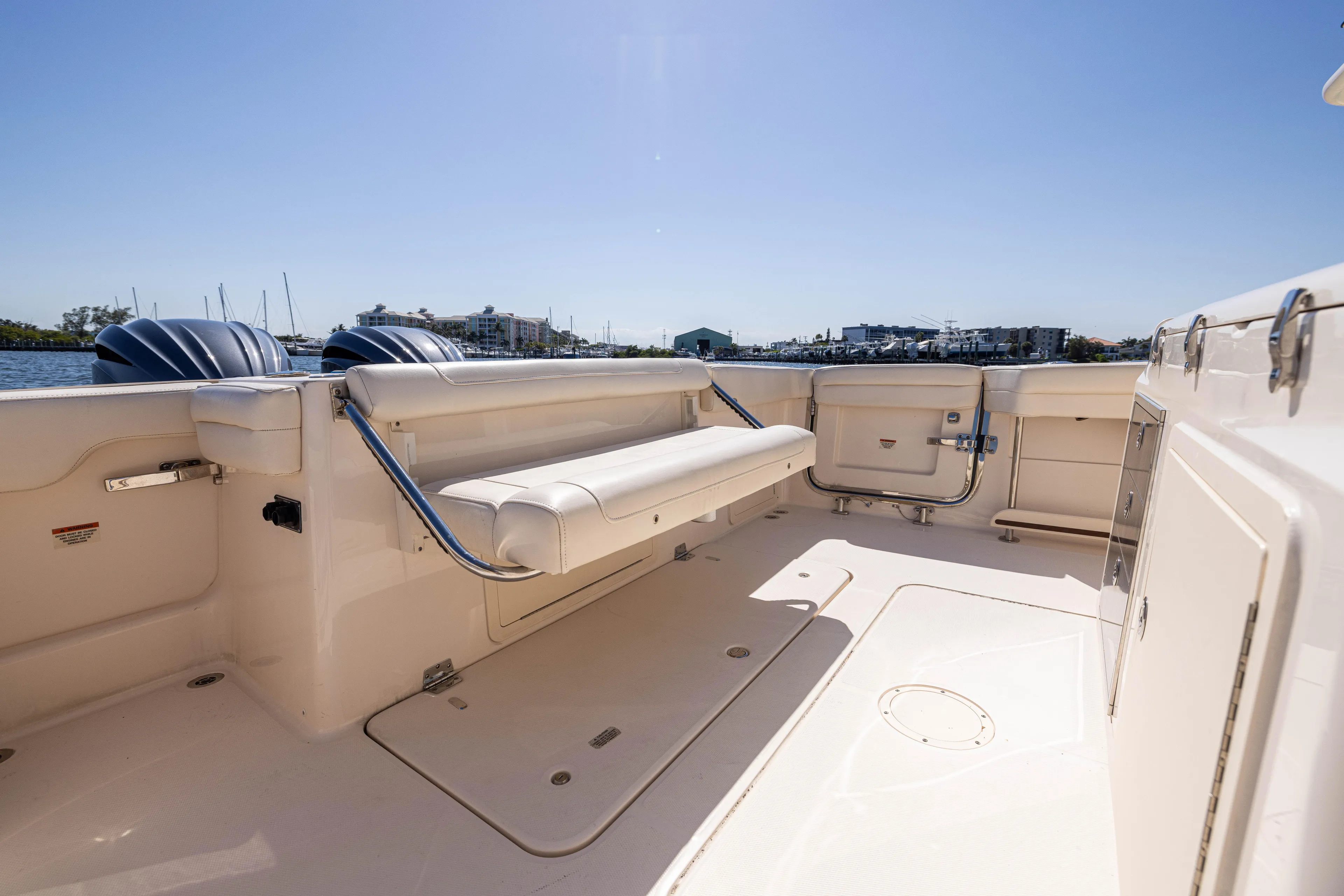 Purple Bags 2 Yacht Photos Pics 2023 Grady-White Canyon 326 boat deck with seating, under clear blue sky.