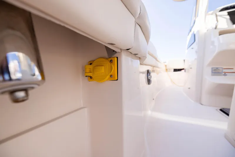 Purple Bags 2 Yacht Photos Pics 2023 Grady-White Canyon 326 boat interior with yellow electrical outlet.