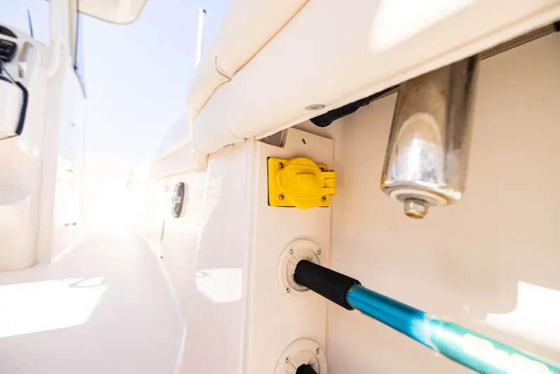 Purple Bags 2 Yacht Photos Pics 2023 Grady-White Canyon 326 boat interior with utility connections and bright lighting.