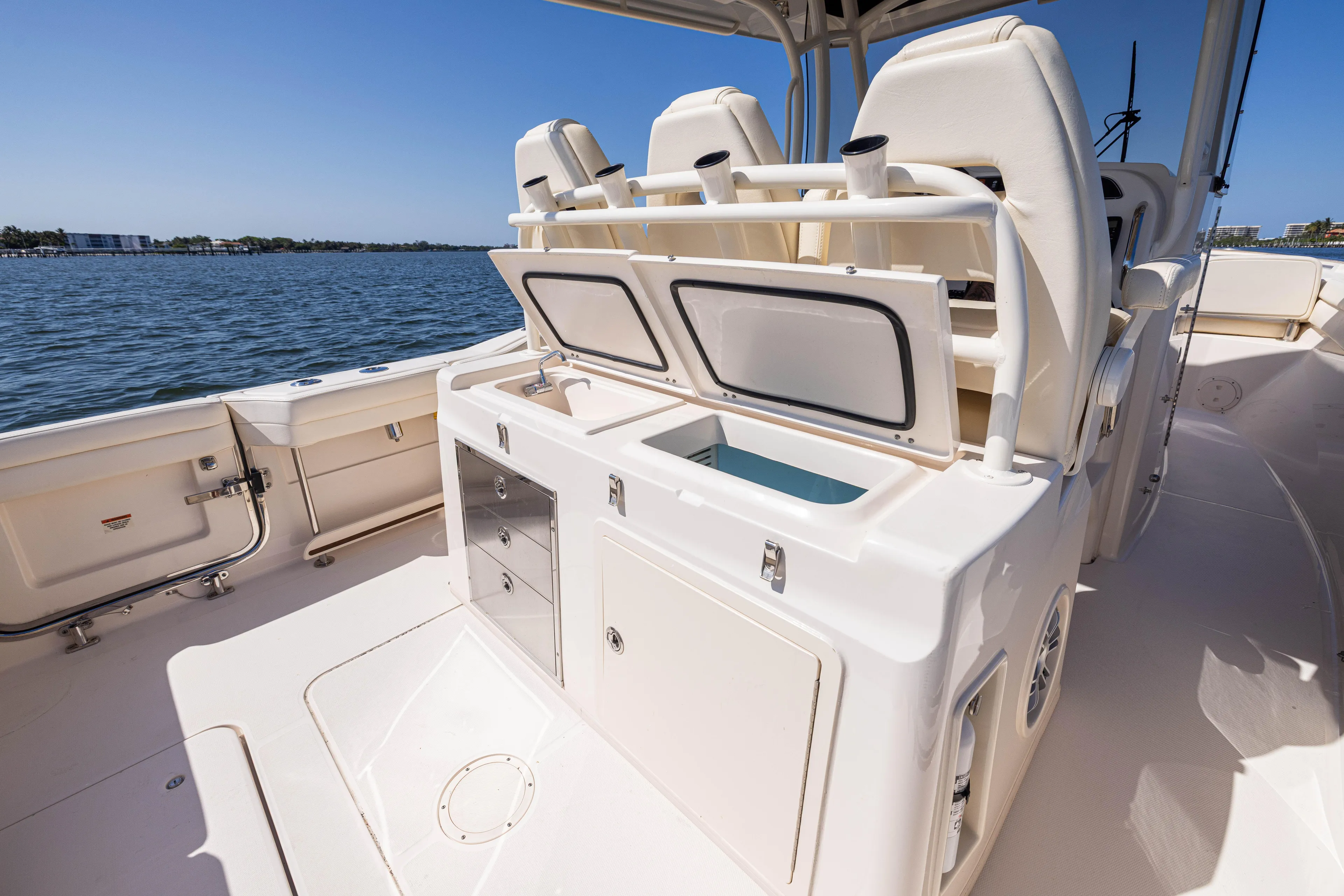 Purple Bags 2 Yacht Photos Pics 2023 Grady-White Canyon 326 boat interior with seating and storage, on a sunny day.