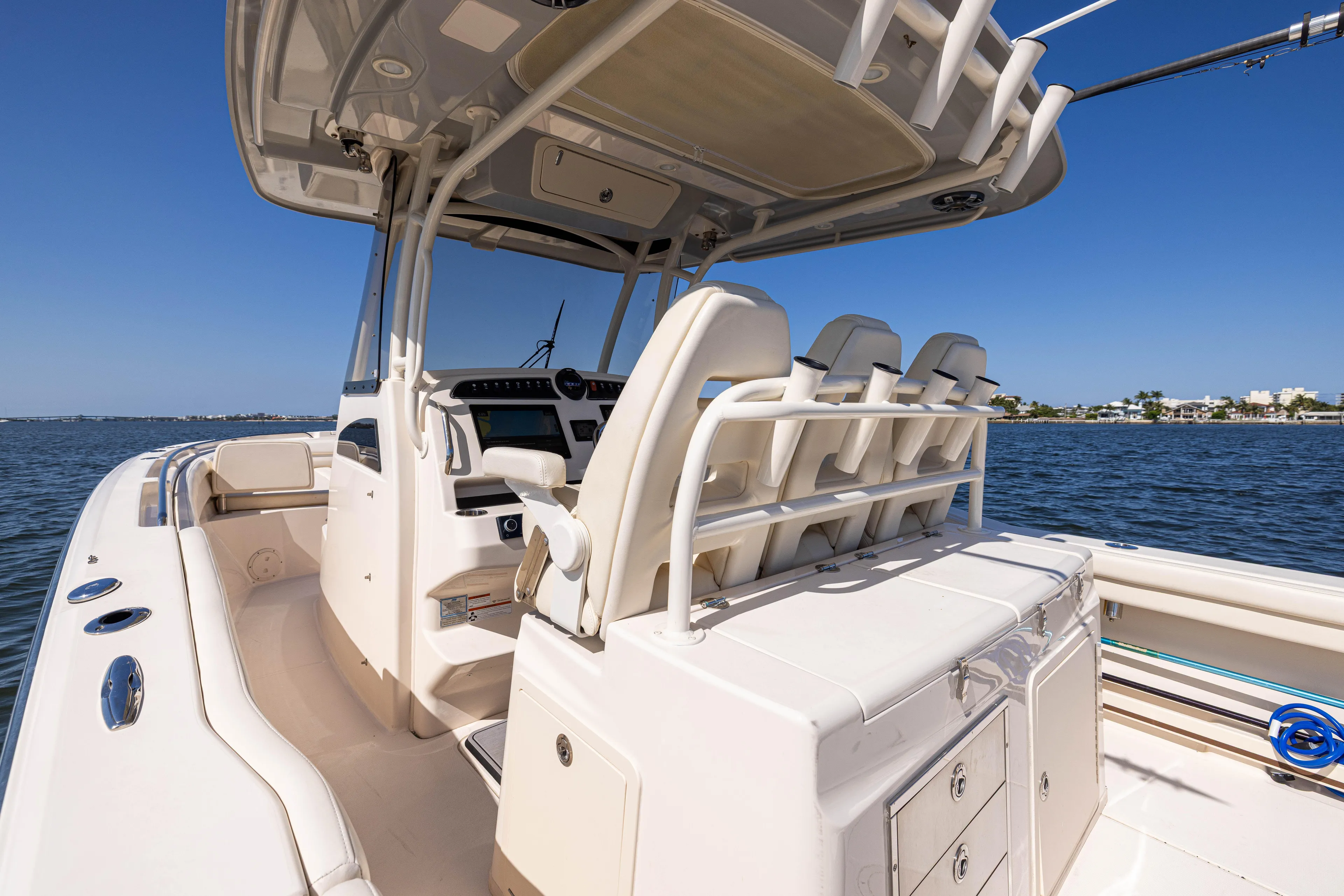 Purple Bags 2 Yacht Photos Pics 2023 Grady-White Canyon 326 boat interior with seating and console, on calm water.