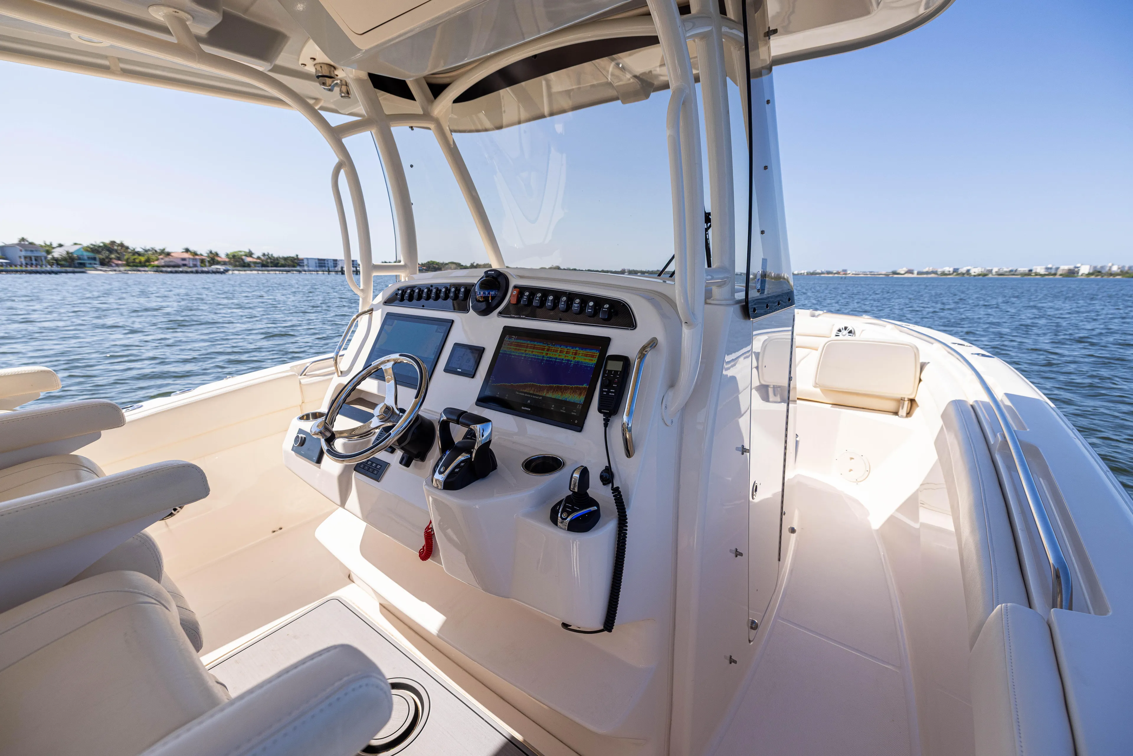 Purple Bags 2 Yacht Photos Pics 2023 Grady-White Canyon 326 boat interior with modern controls on a sunny day.