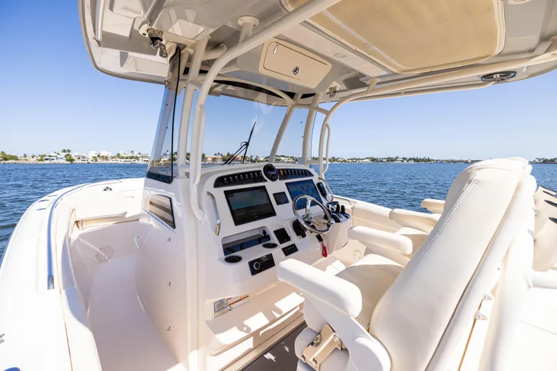 Purple Bags 2 Yacht Photos Pics 2023 Grady-White Canyon 326 boat interior with advanced navigation system on open water.