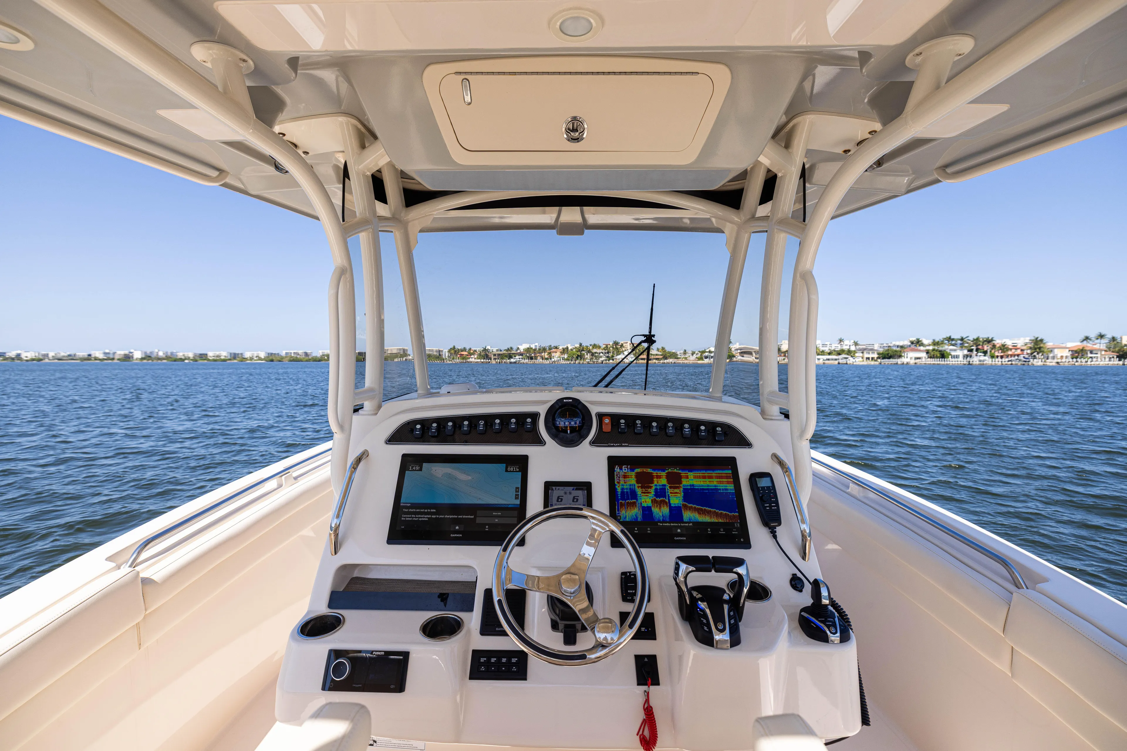 Purple Bags 2 Yacht Photos Pics 2023 Grady-White Canyon 326 boat helm with advanced navigation systems on open water.