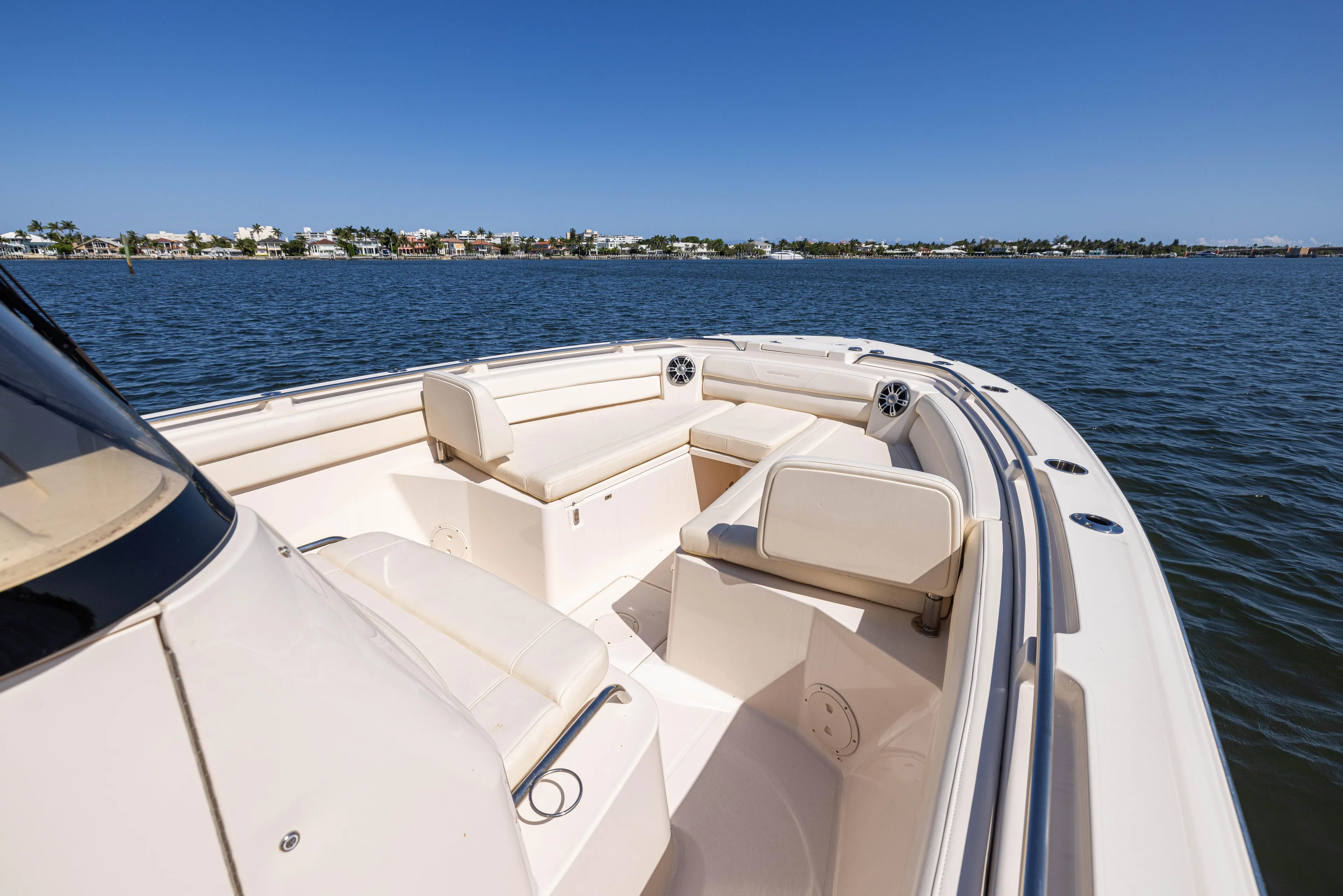 Purple Bags 2 Yacht Photos Pics 2023 Grady-White Canyon 326 boat interior with seating, on calm water.
