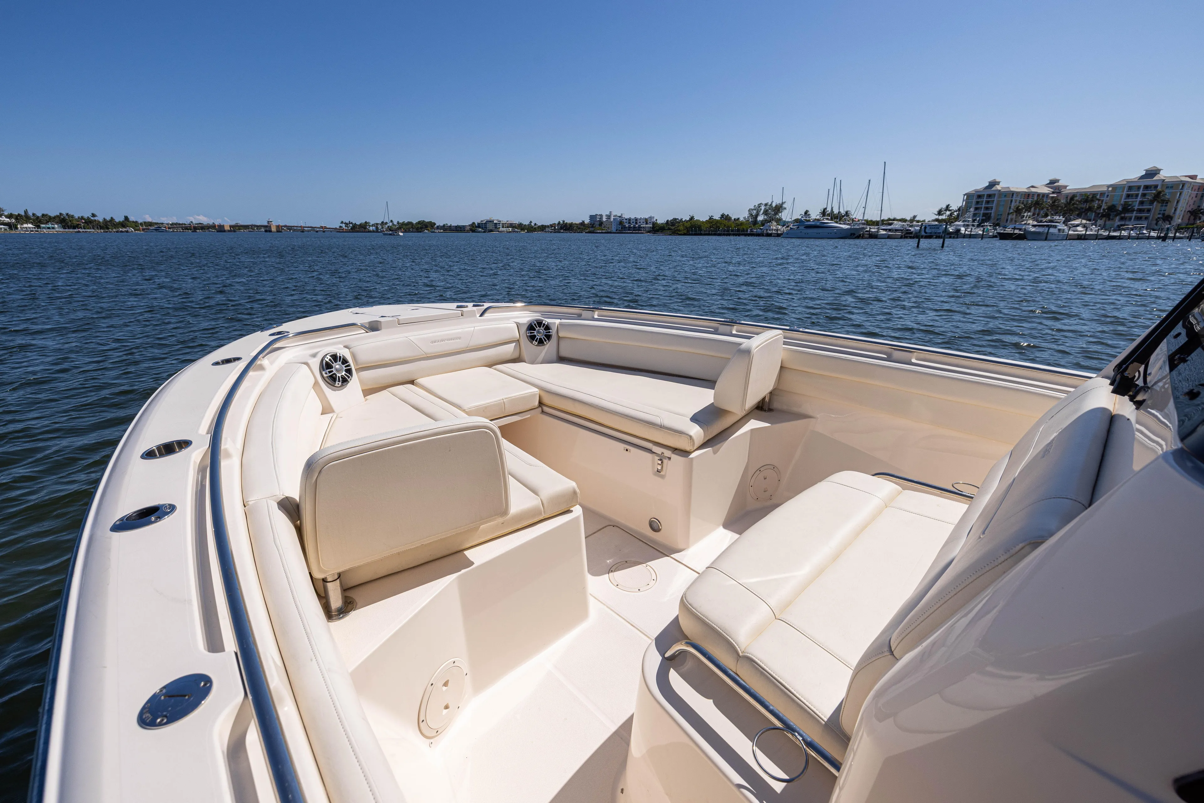 Purple Bags 2 Yacht Photos Pics 2023 Grady-White Canyon 326 boat interior with seating, on calm water.
