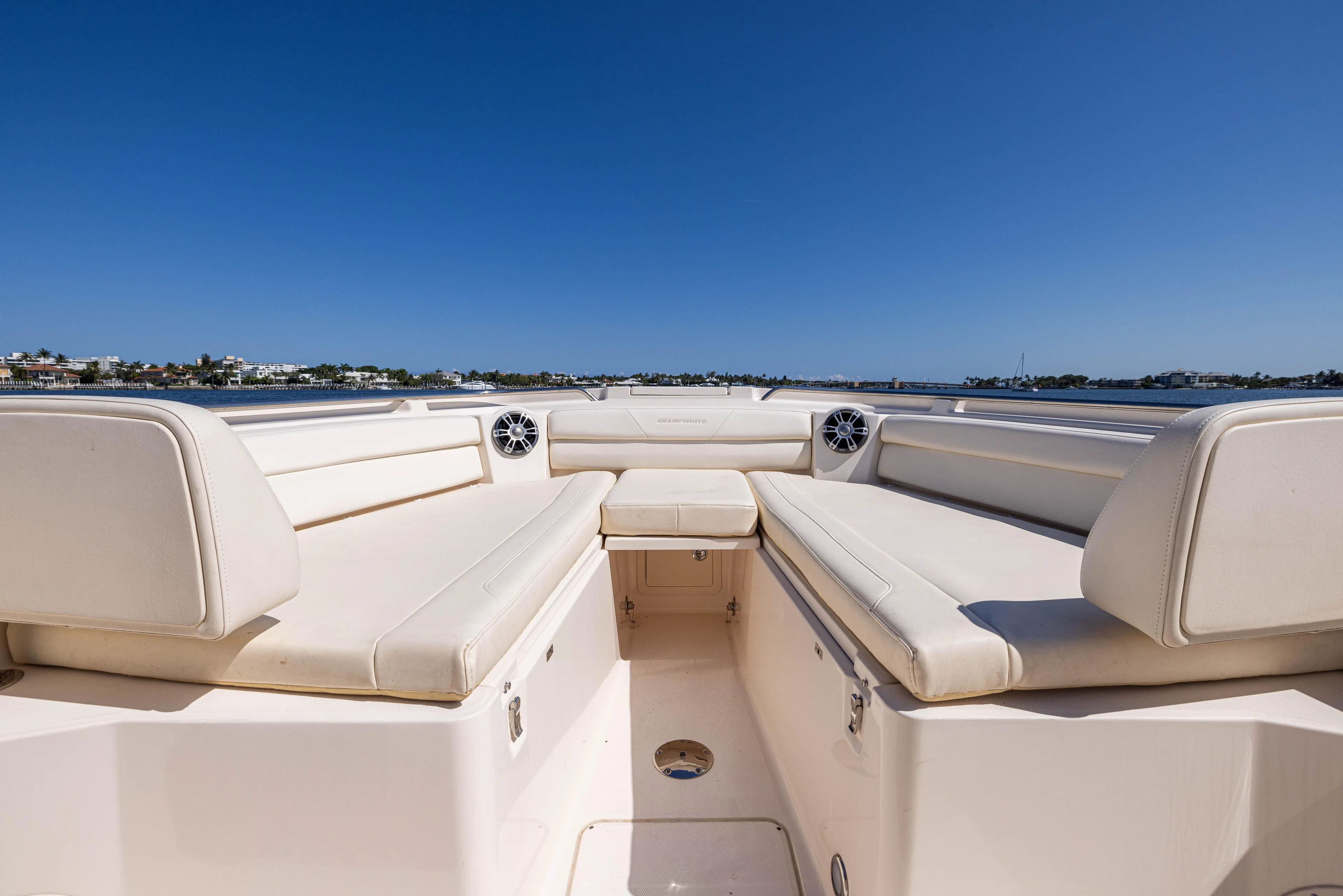 Purple Bags 2 Yacht Photos Pics 2023 Grady-White Canyon 326 boat interior with spacious seating and clear blue sky.