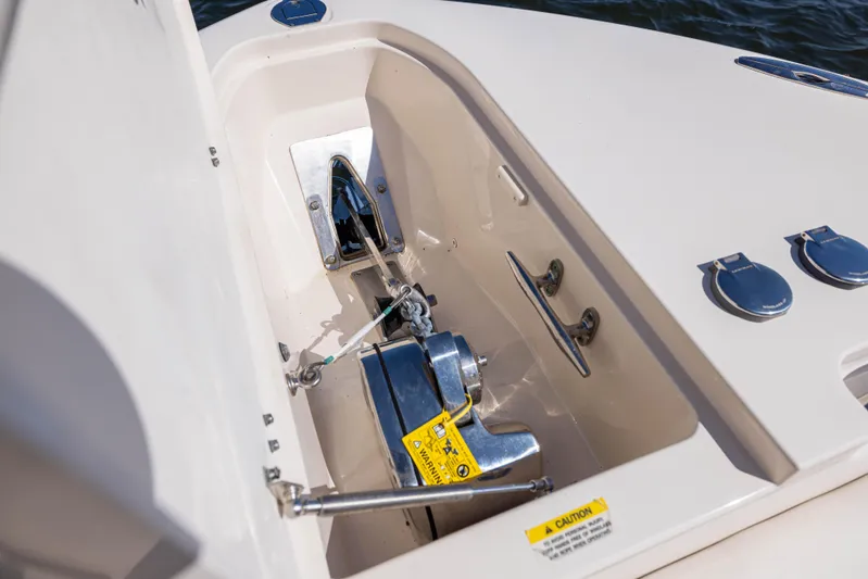 Purple Bags 2 Yacht Photos Pics 2023 Grady-White Canyon 326 anchor compartment with stainless steel fittings and safety label.