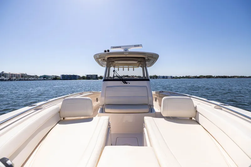 Purple Bags 2 Yacht Photos Pics 2023 Grady-White Canyon 326 boat on open water under clear blue sky.