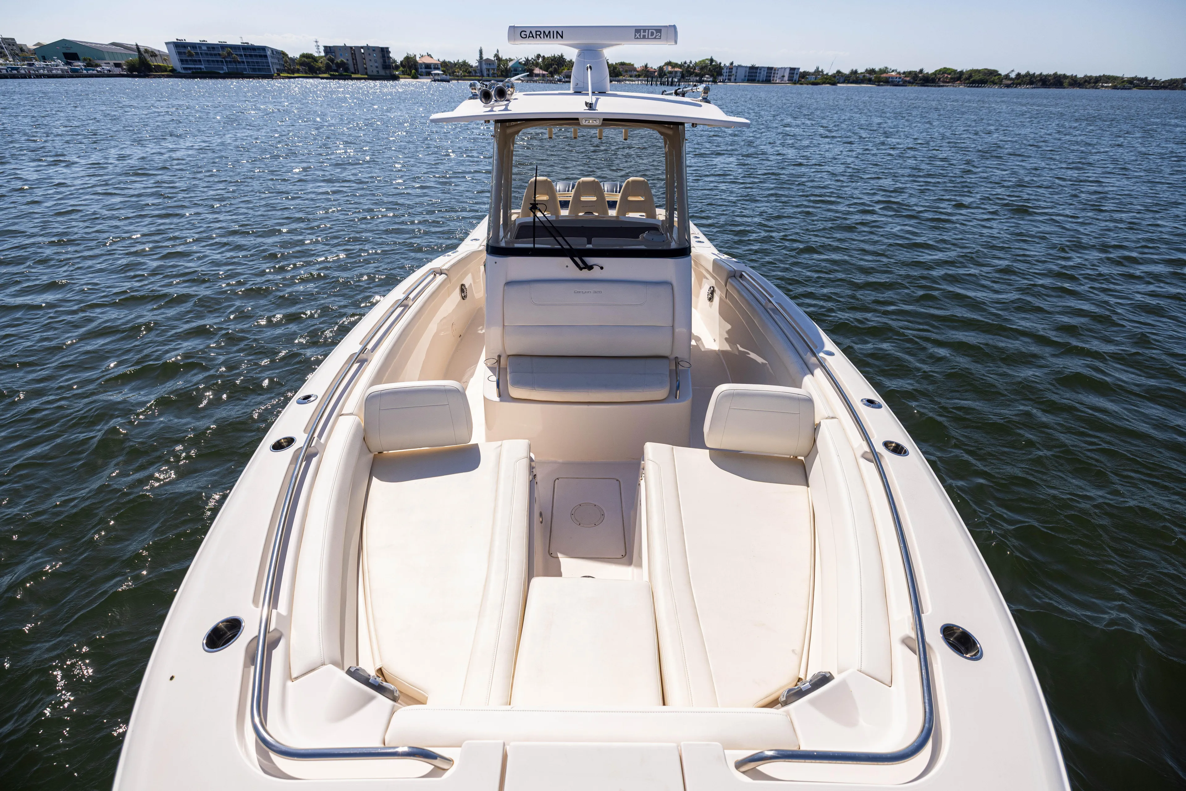 Purple Bags 2 Yacht Photos Pics 2023 Grady-White Canyon 326 boat on water, showcasing spacious deck and seating.