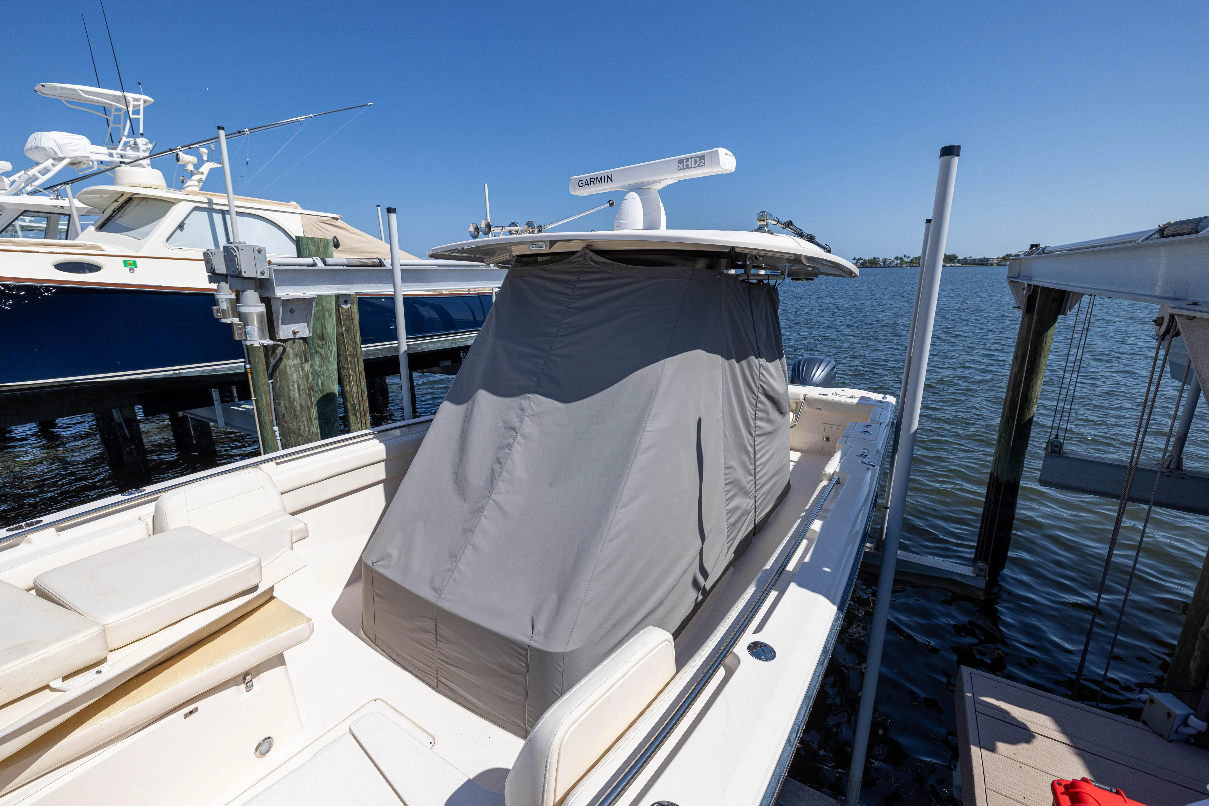 Purple Bags 2 Yacht Photos Pics 2023 Grady-White Canyon 326 boat docked, covered console, sunny day, marina background.