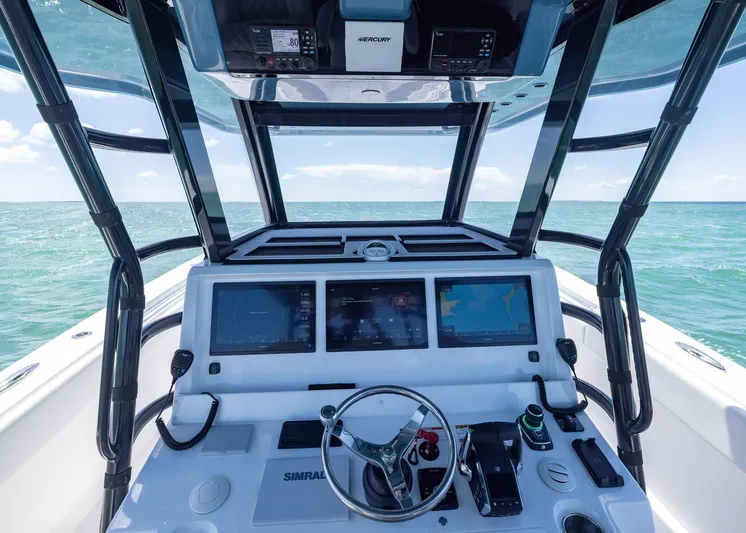  Yacht Photos Pics 2025 Invincible 43 Open Fisherman helm with advanced navigation systems on open sea.