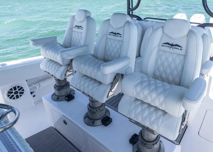  Yacht Photos Pics Luxurious seating on 2025 Invincible 43 Open Fisherman boat, featuring elegant white upholstery.