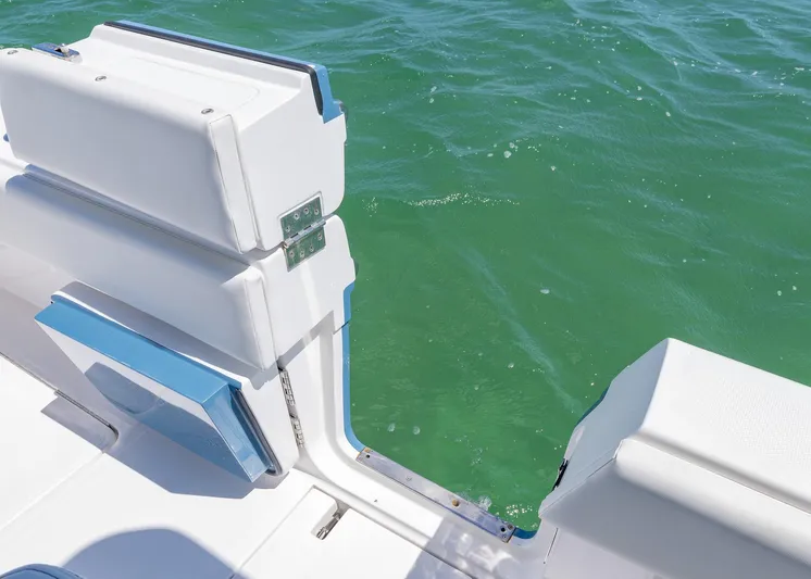  Yacht Photos Pics 2025 Invincible 43 Open Fisherman boat with open side door on turquoise water.