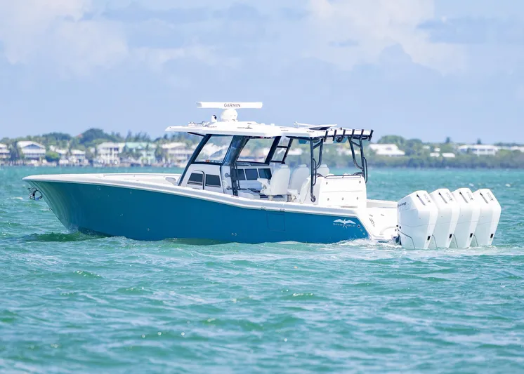 Yacht Photos Pics 2025 Invincible 43 Open Fisherman boat cruising on clear blue water.