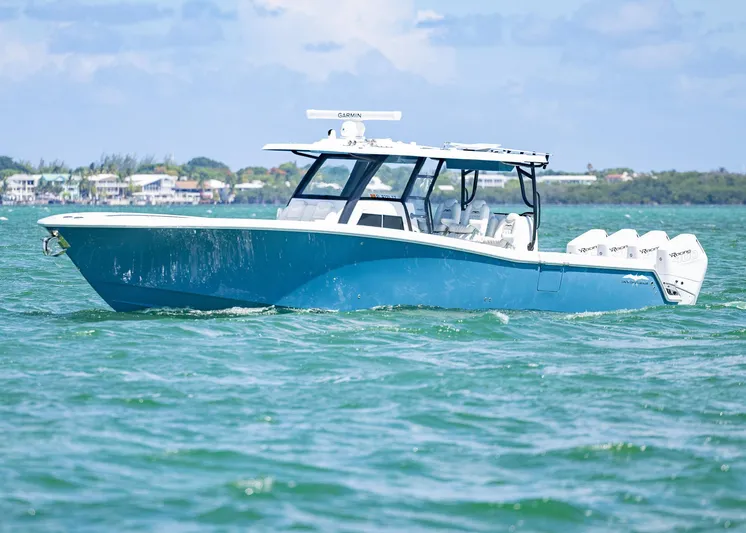  Yacht Photos Pics 2025 Invincible 43 Open Fisherman boat on water, featuring sleek design and multiple engines.