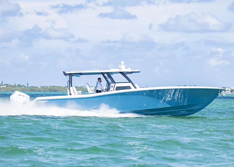  Yacht Photos Pics 2025 Invincible 43 Open Fisherman cruising on clear blue waters.