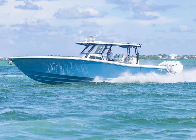  Yacht Photos Pics 2025 Invincible 43 Open Fisherman cruising on blue ocean waters.