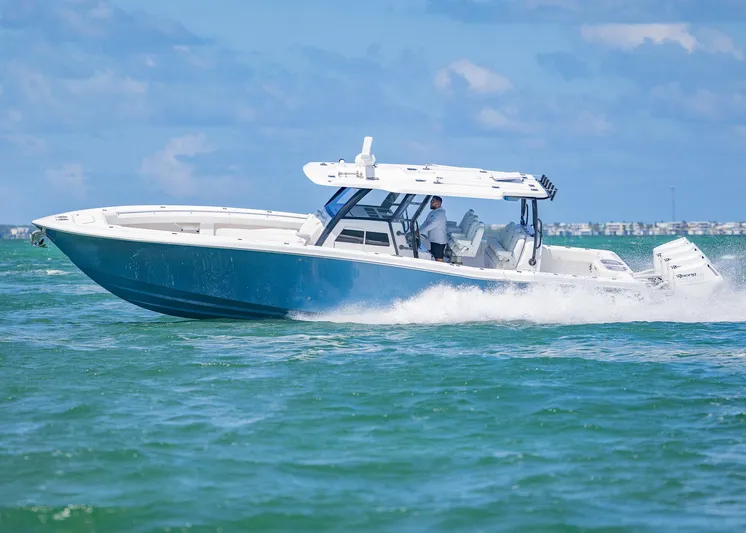  Yacht Photos Pics 2025 Invincible 43 Open Fisherman cruising on open water under blue skies.